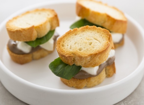 Tostino di baguette con mozzarella, crema di acciughe e basilico
