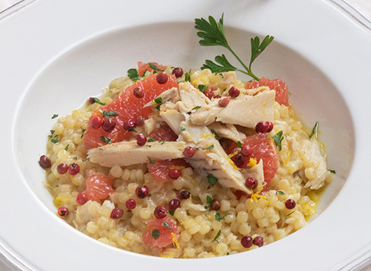 Fregola con filetti di sgombro, pompelmo e bacche di pepe rosa